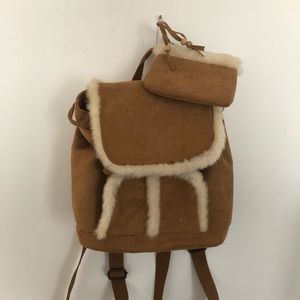 Mini backpack with faux fur outlining.